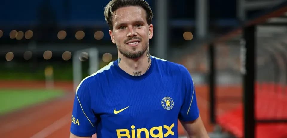 Football player in blue Chelsea jersey smiling