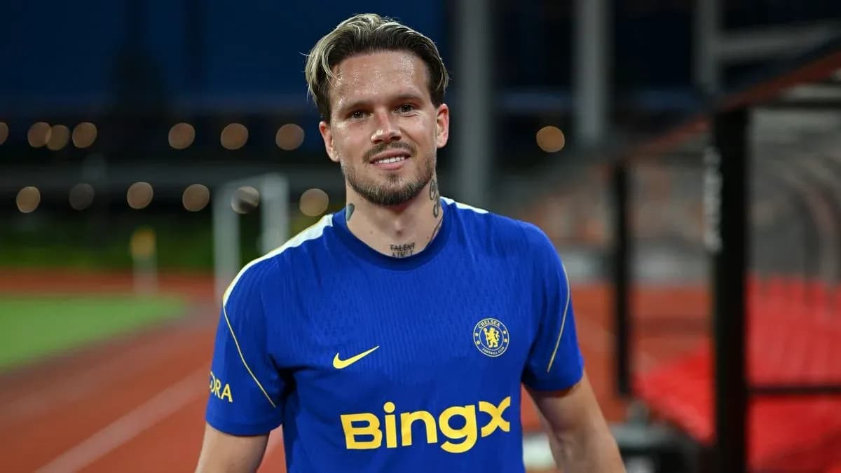 Football player in blue Chelsea jersey smiling