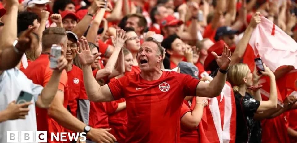 Fans celebrating in red clothing at a sporting event