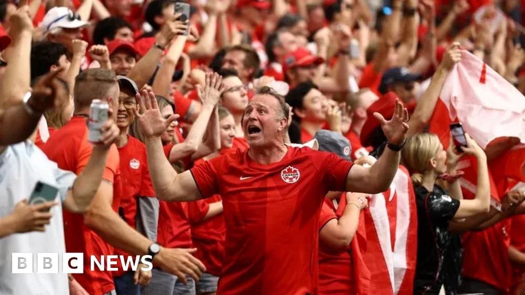 Fans celebrating in red clothing at a sporting event