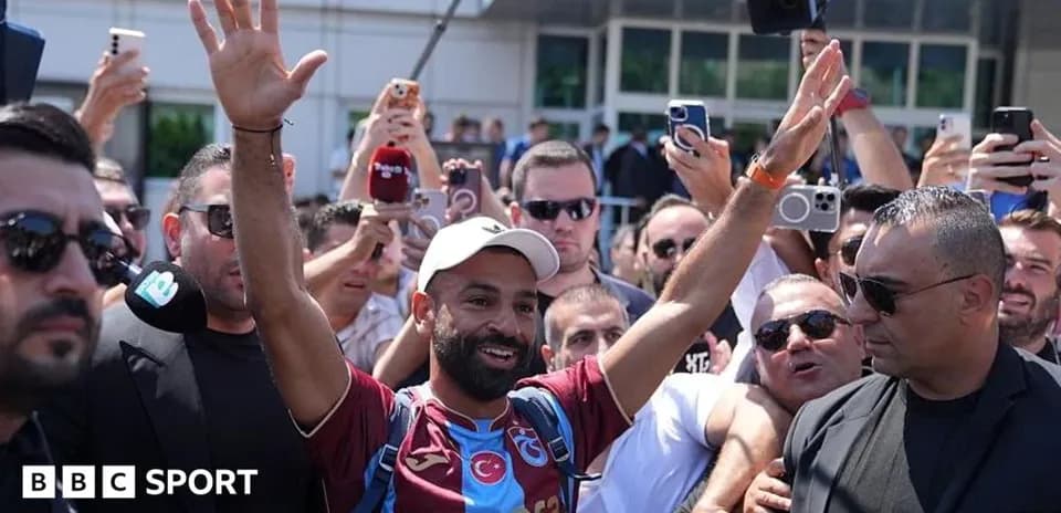 Player waving to fans during arrival at venue