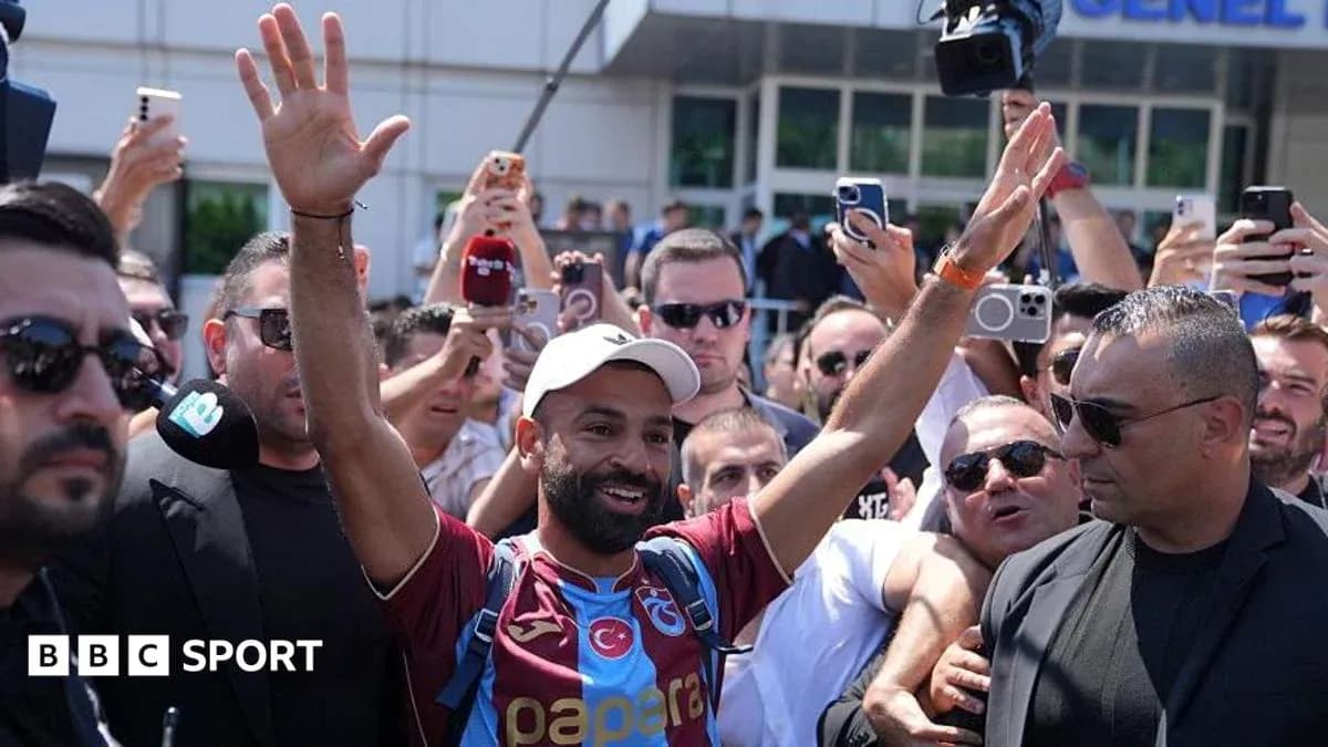 Player waving to fans during arrival at venue