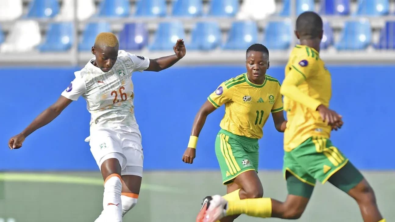 Ivorian player kicking ball against South African opponents