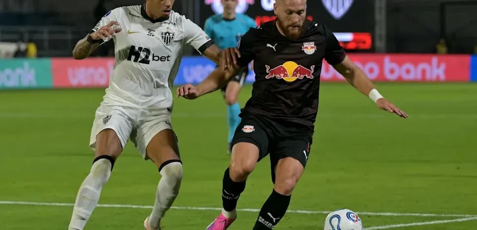 Two players competing for the ball on the field