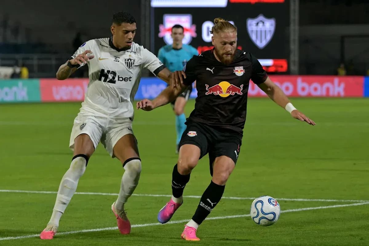 Two players competing for the ball on the field Two players competing for the ball on the field