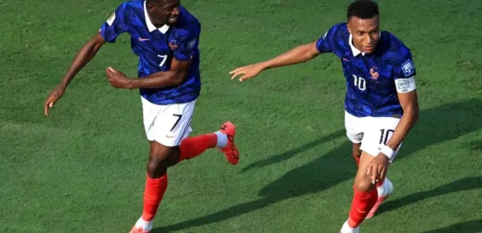 Two players celebrating a goal on the field