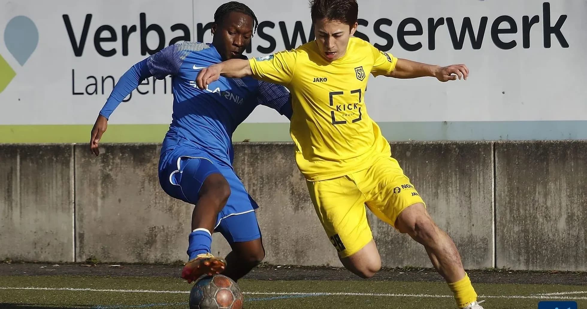 Two players battling for the ball in football match