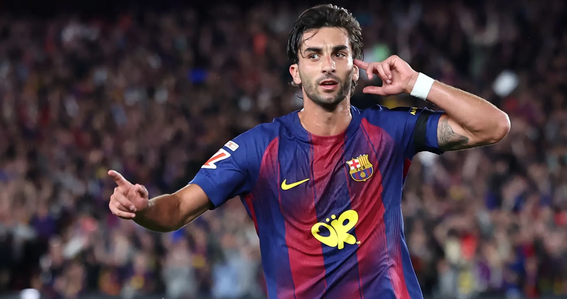 Barcelona player celebrating goal with hand gesture