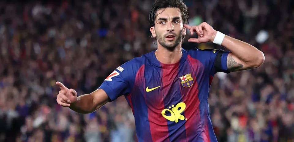 Barcelona player celebrating goal with hand gesture