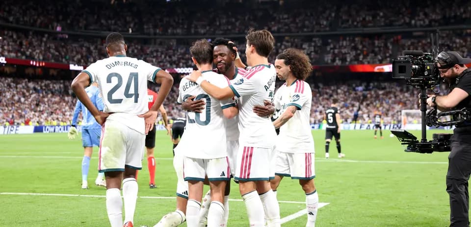 Players celebrating a goal on the field
