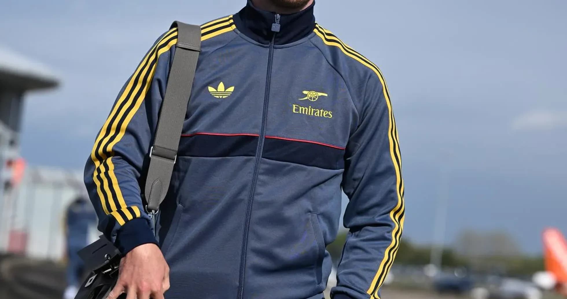 Man in sportswear walking with a bag