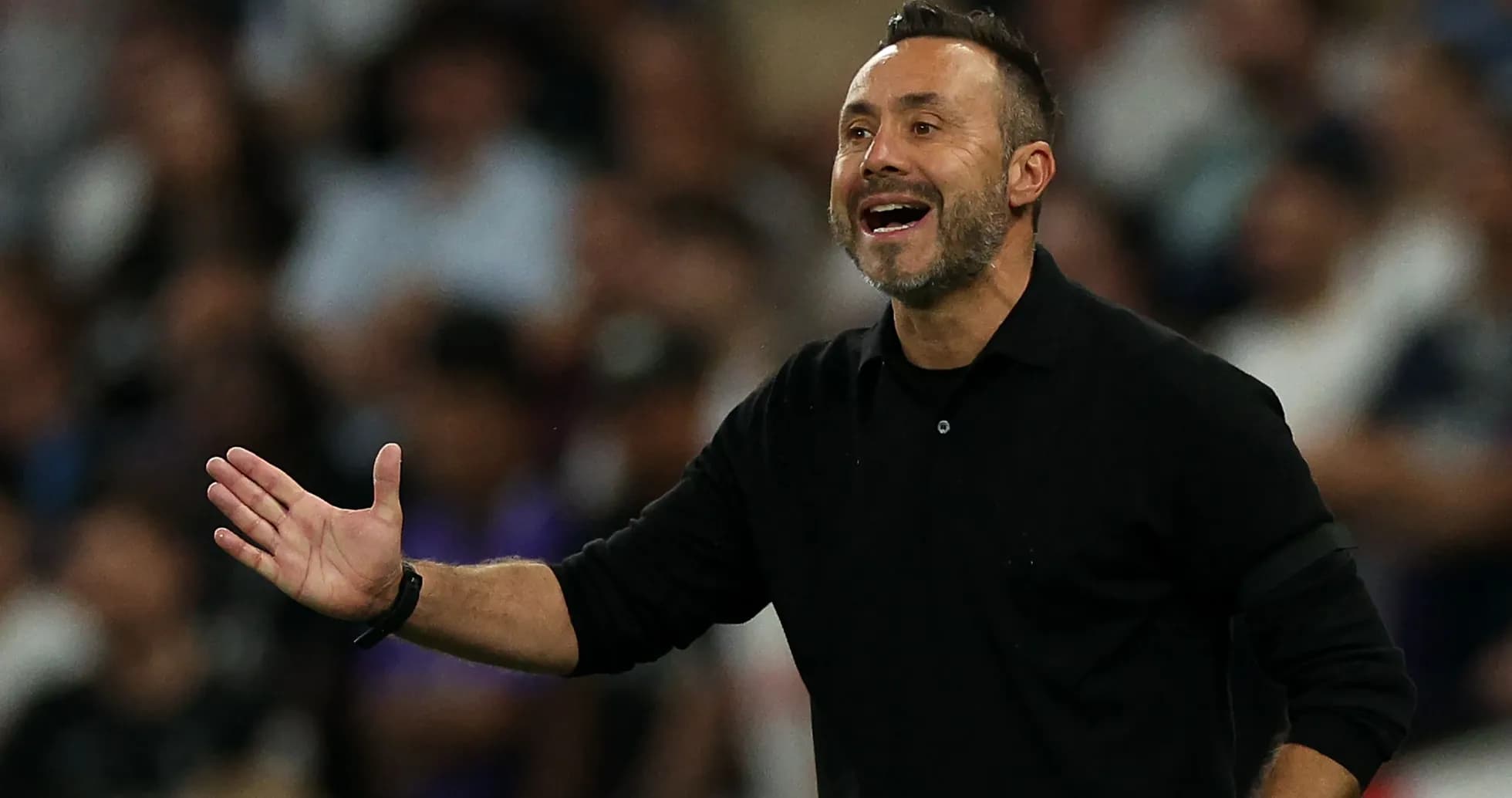 Coach gesturing during a match from the sidelines