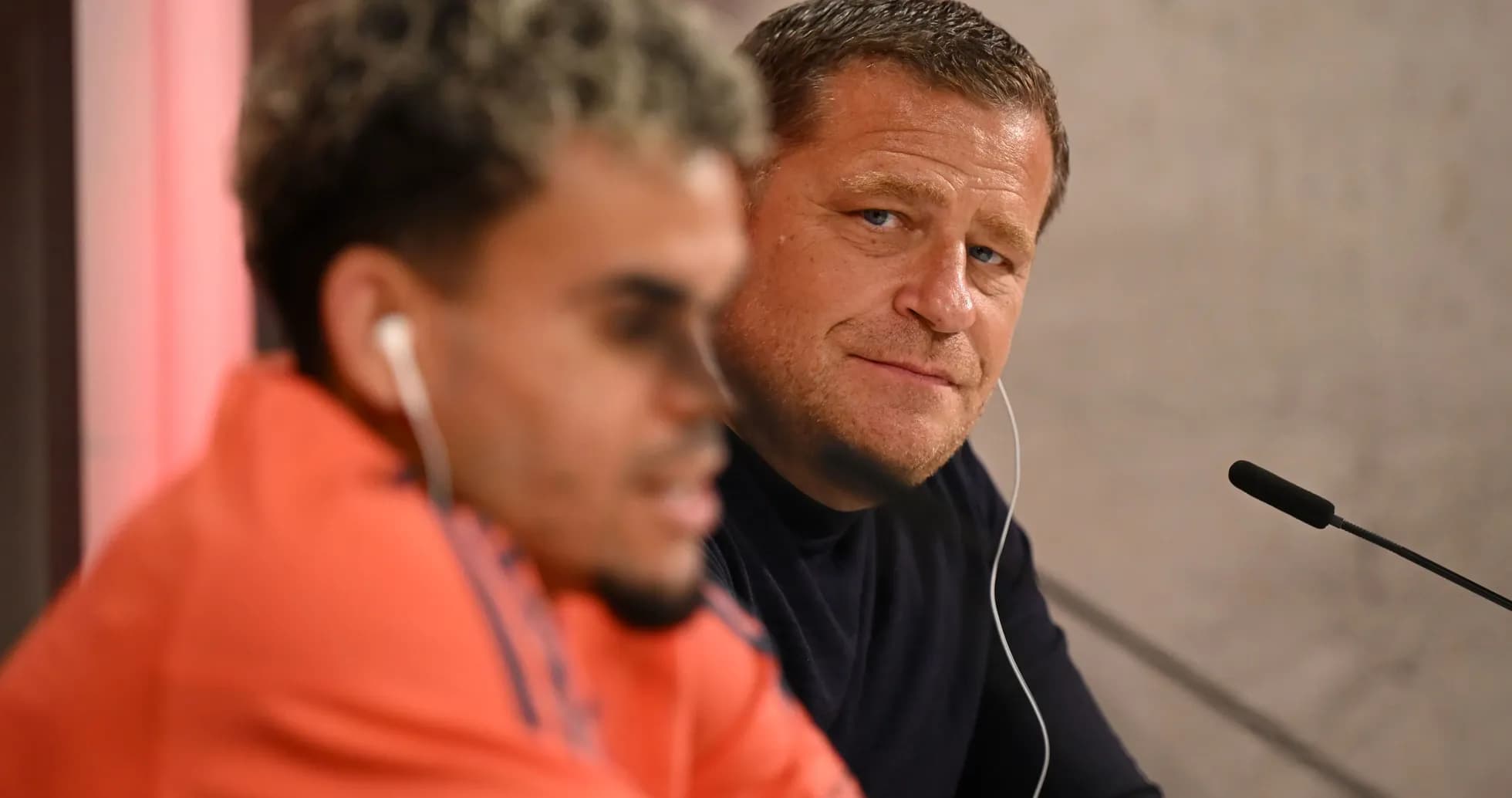 Two speakers at a press conference table
