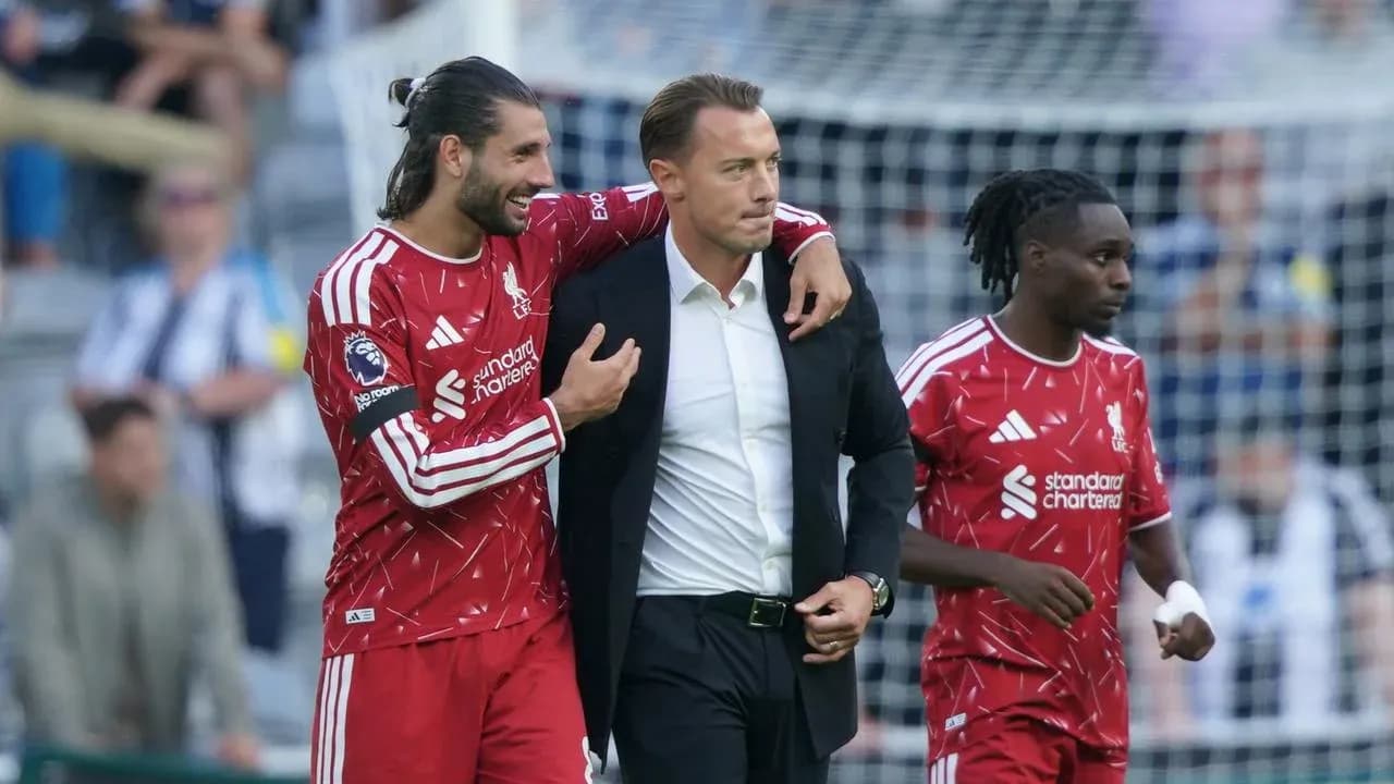 Liverpool players celebrating with their coach on field