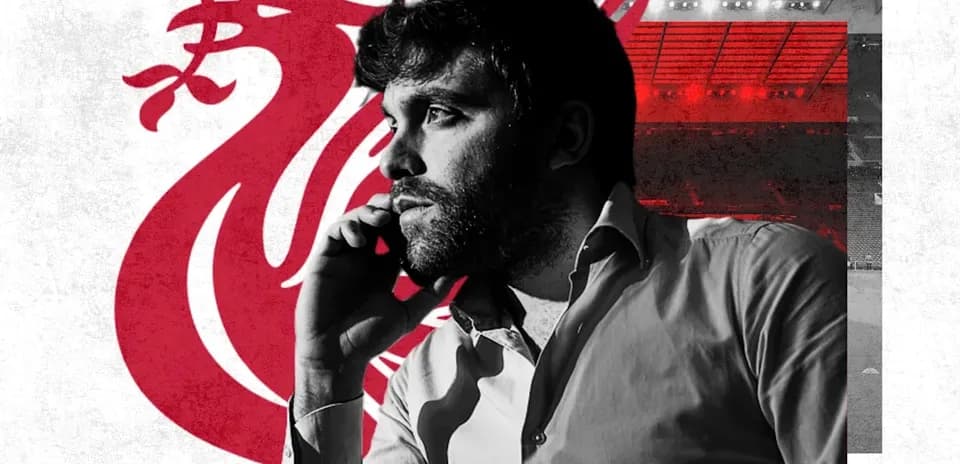 Man on phone with Liverpool logo in background