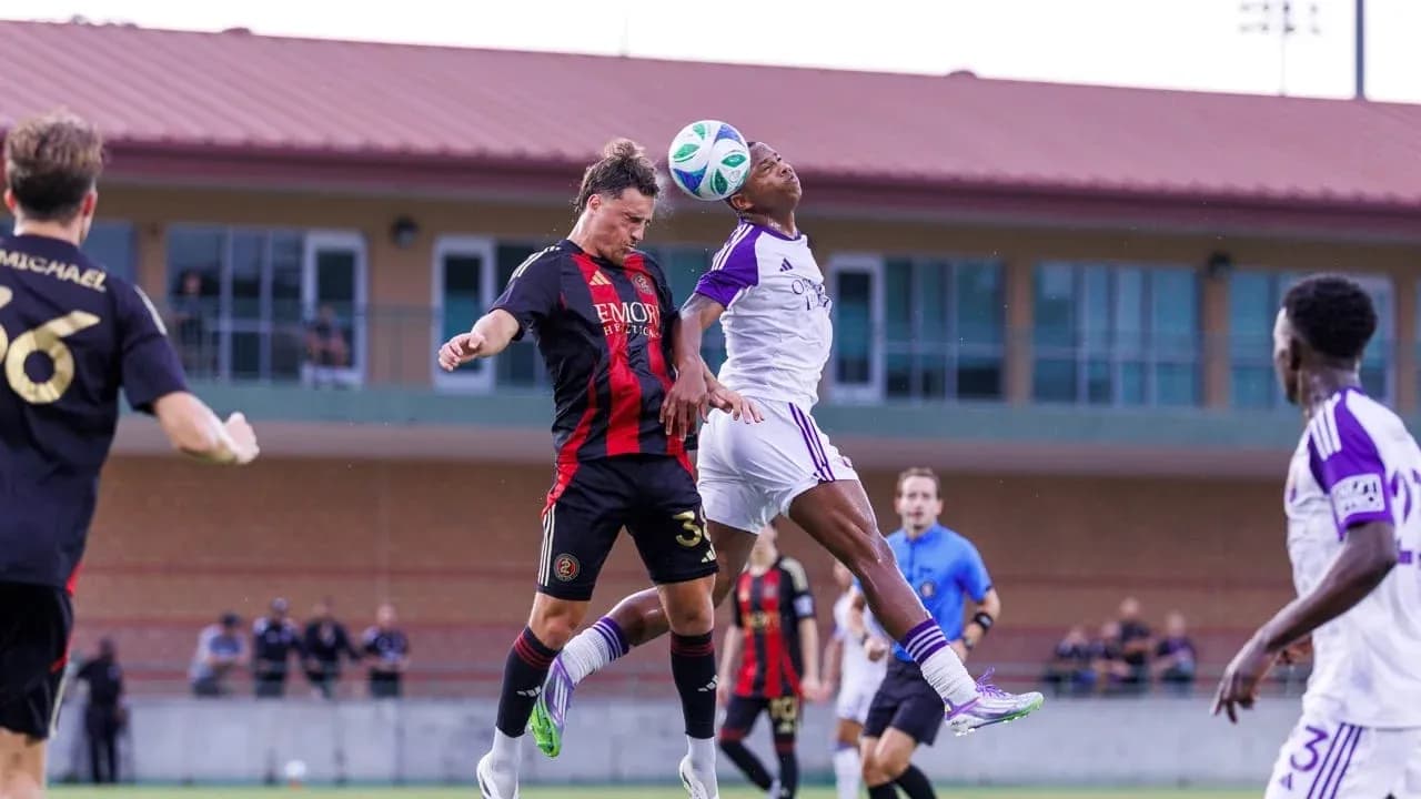 Players contesting a header during MLS Next Pro match