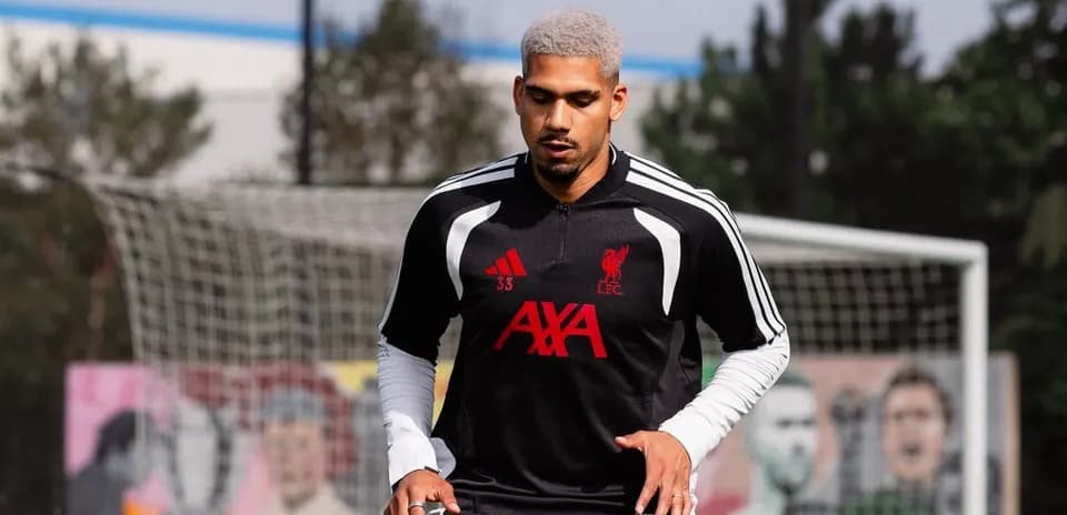 Player training on pitch with Liverpool FC kit