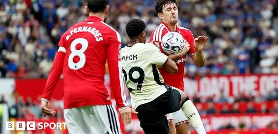 Player kicking ball while opponent defends during match