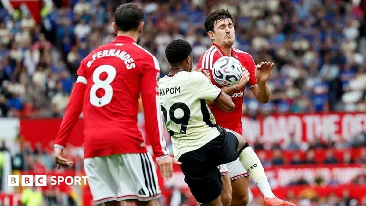 Player kicking ball while opponent defends during match