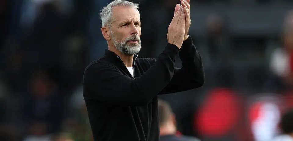 Coach applauding during a match on the sideline