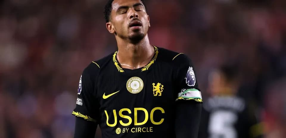 Player in black jersey with captain's armband during match