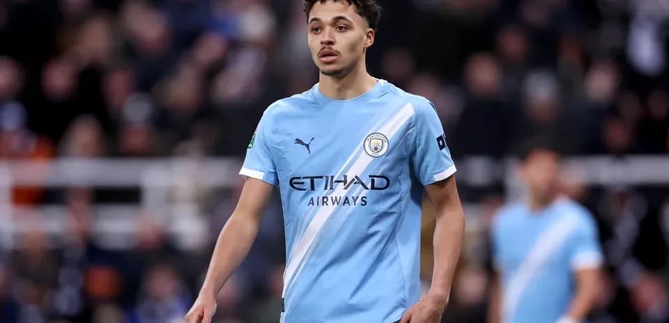 Player in light blue Manchester City kit on pitch