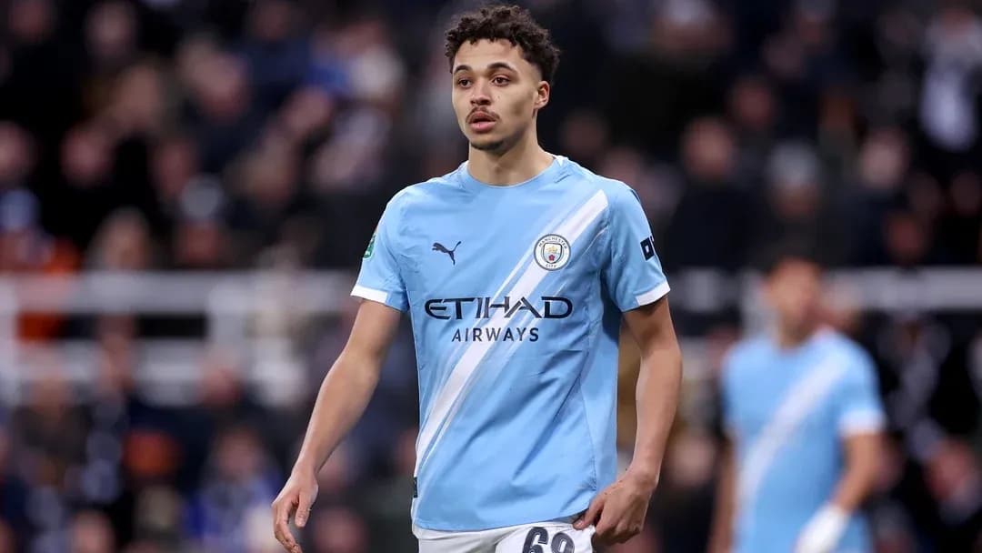Player in light blue Manchester City kit on pitch