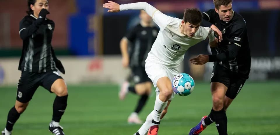 Players competing for the ball in USL Championship match