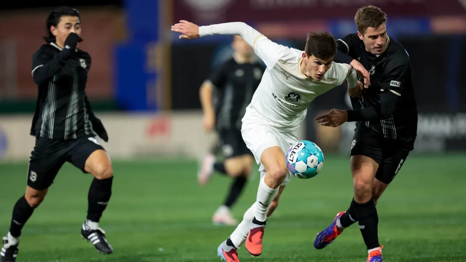 Players competing for the ball in USL Championship match