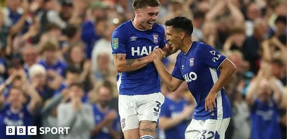 Two Ipswich Town players celebrating a goal together