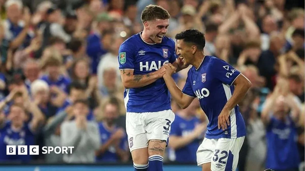 Two Ipswich Town players celebrating a goal together