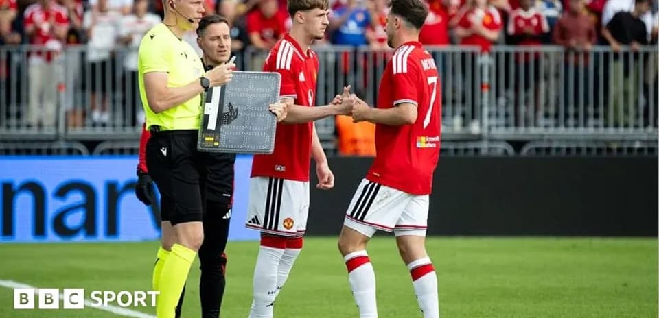 Players exchanging handshakes during substitution in match