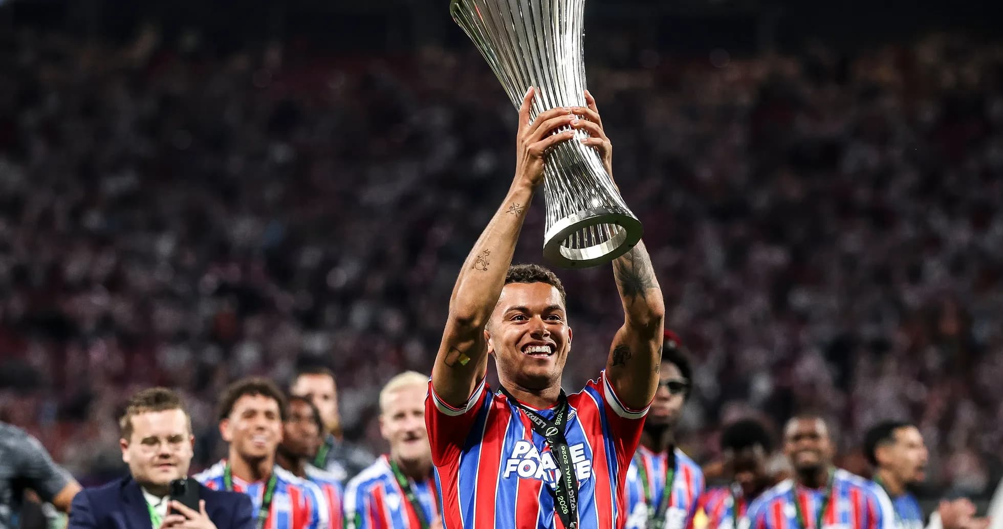 Player celebrating with trophy after match victory