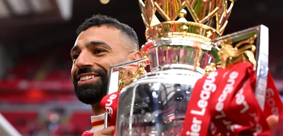 Player celebrating with Premier League trophy