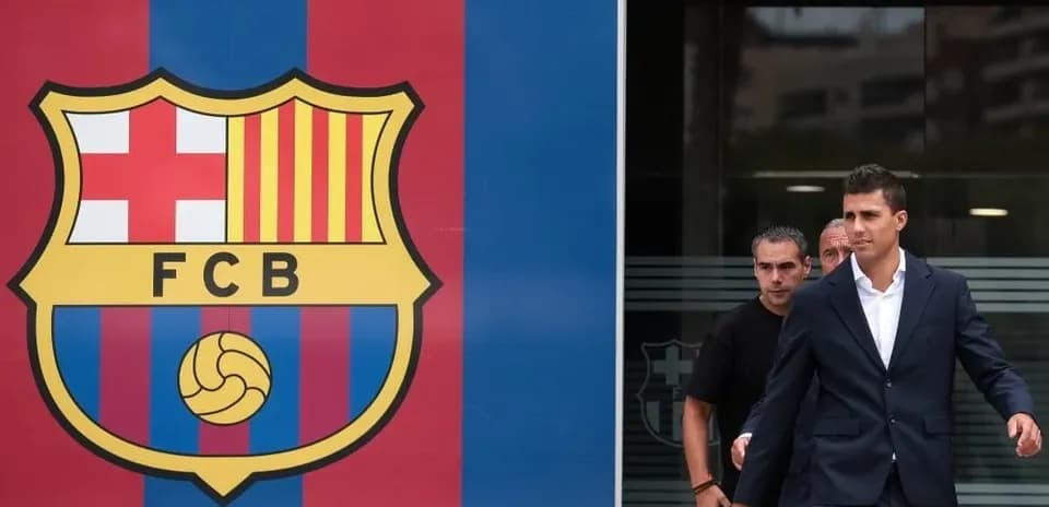 Player leaving FC Barcelona headquarters in suit
