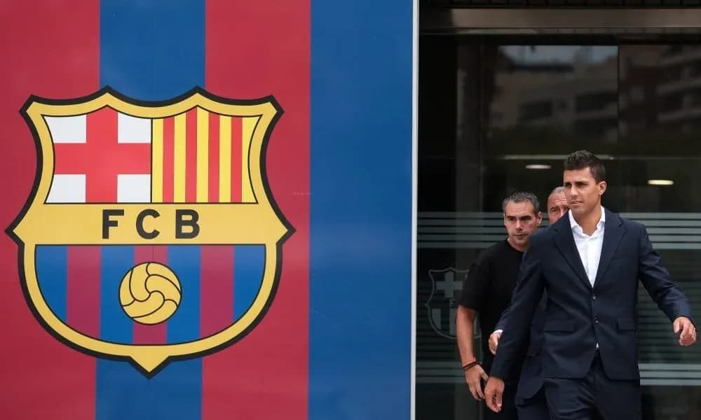 Player leaving FC Barcelona headquarters in suit