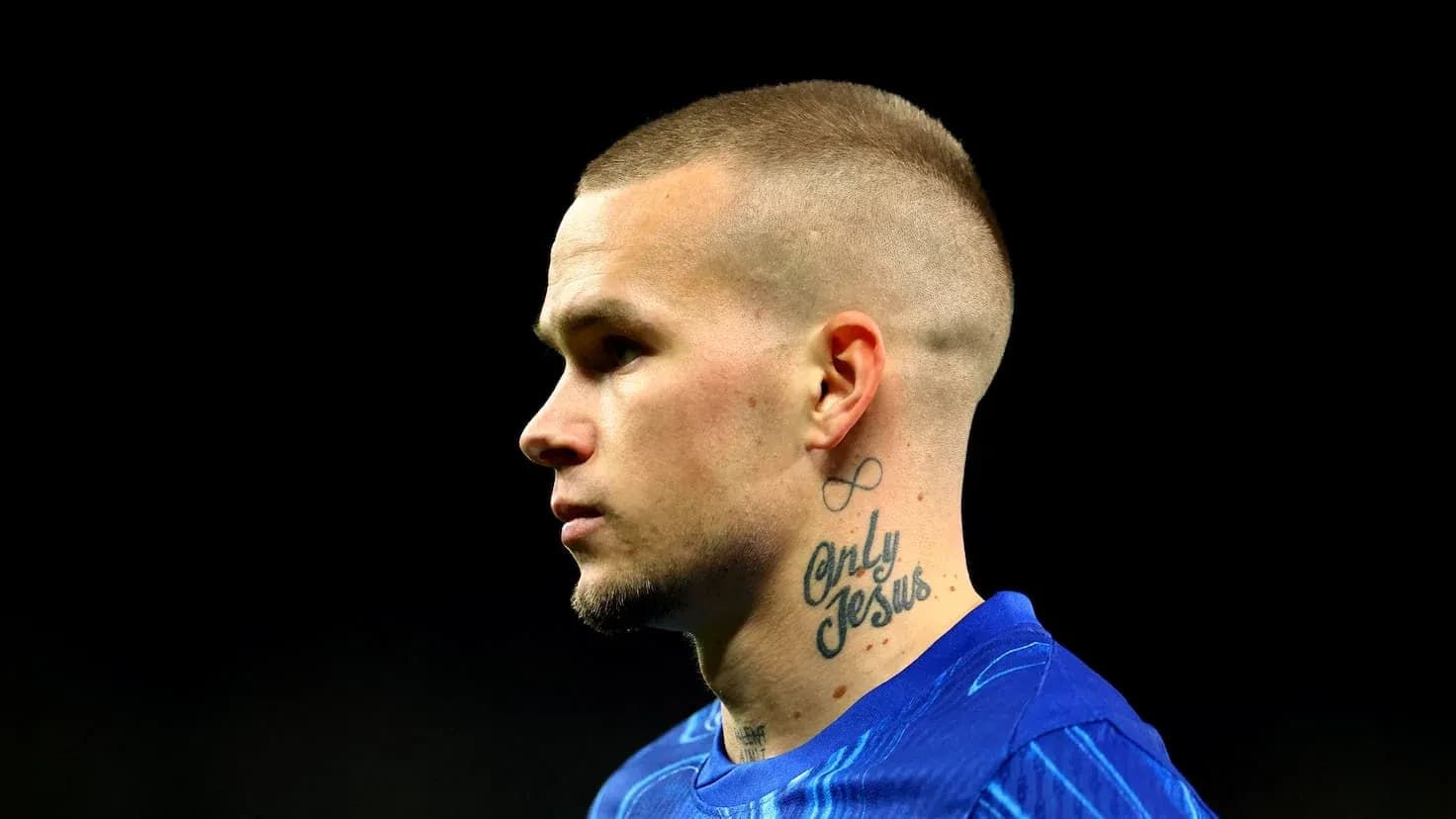 Player with tattoos in blue jersey profile view