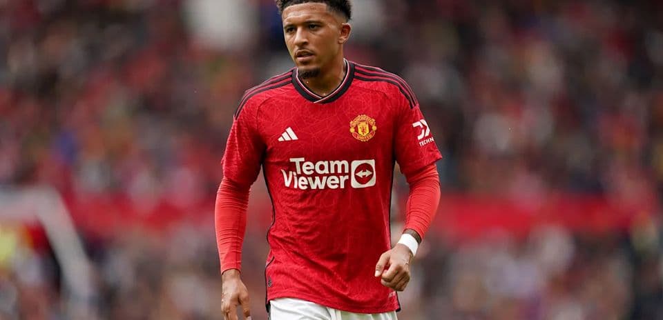 Player walking on pitch in Manchester United jersey