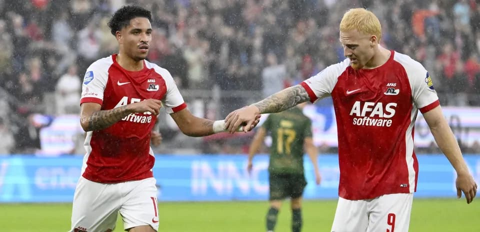 Two AZ Alkmaar players celebrating on the pitch
