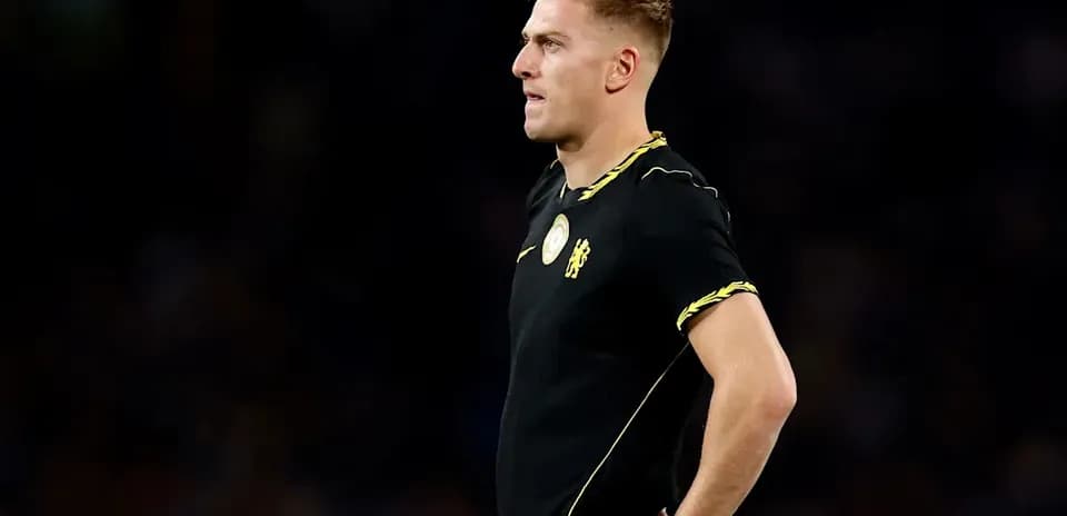 Player in black jersey standing during match