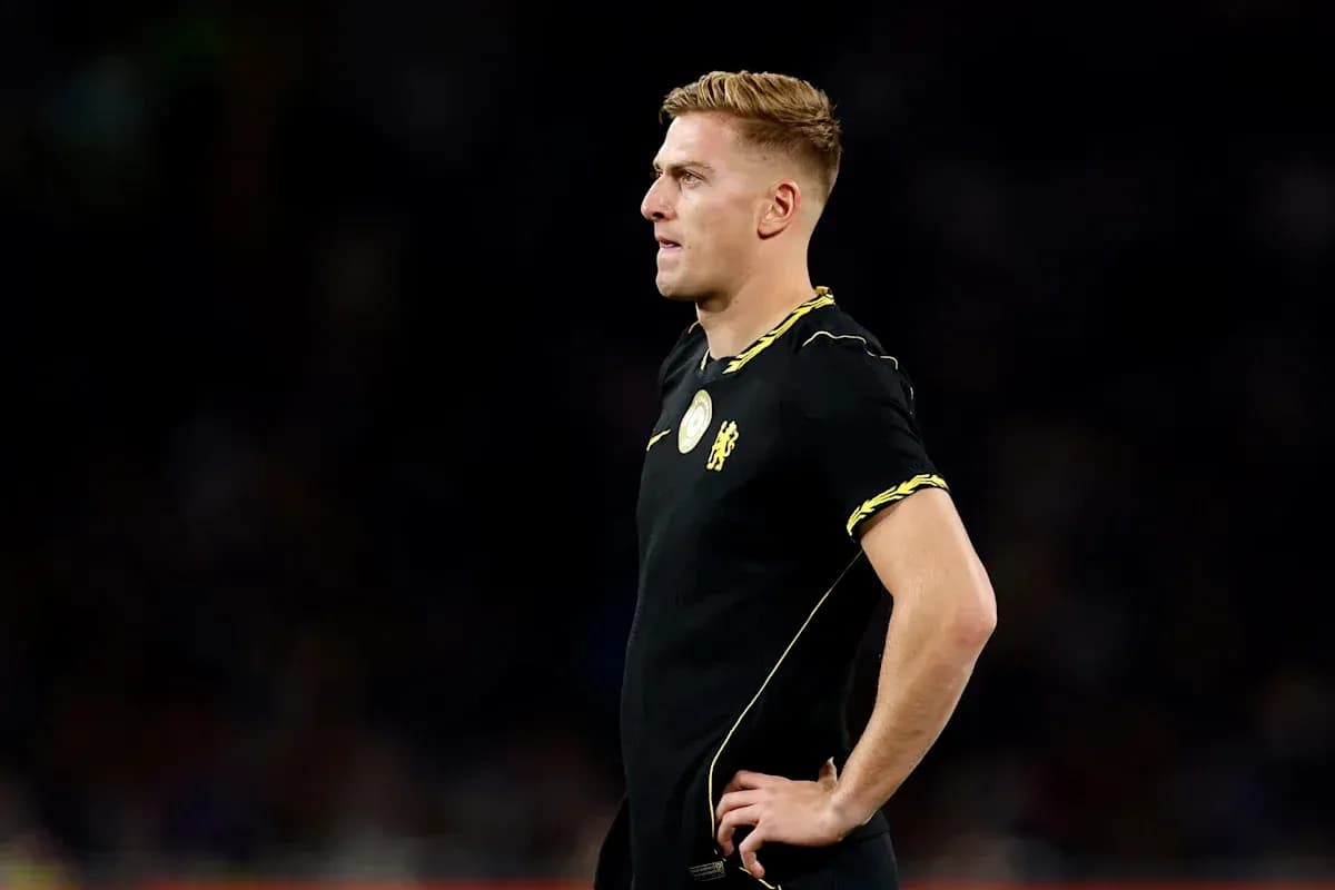 Player in black jersey standing during match