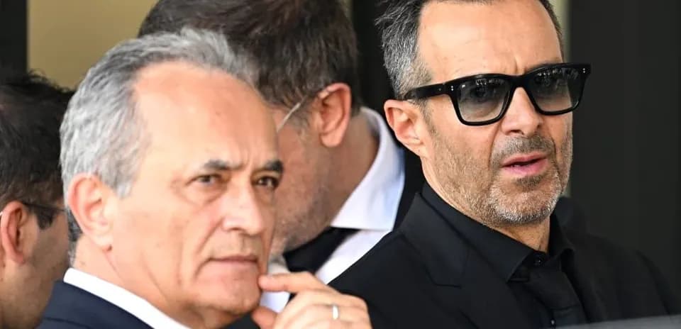 Two men in suits at a public event
