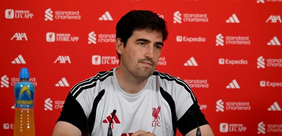 Coach at press conference with Liverpool branding