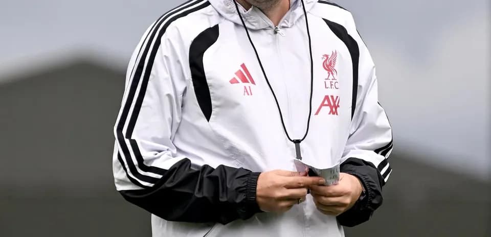 Liverpool coach smiling during training session