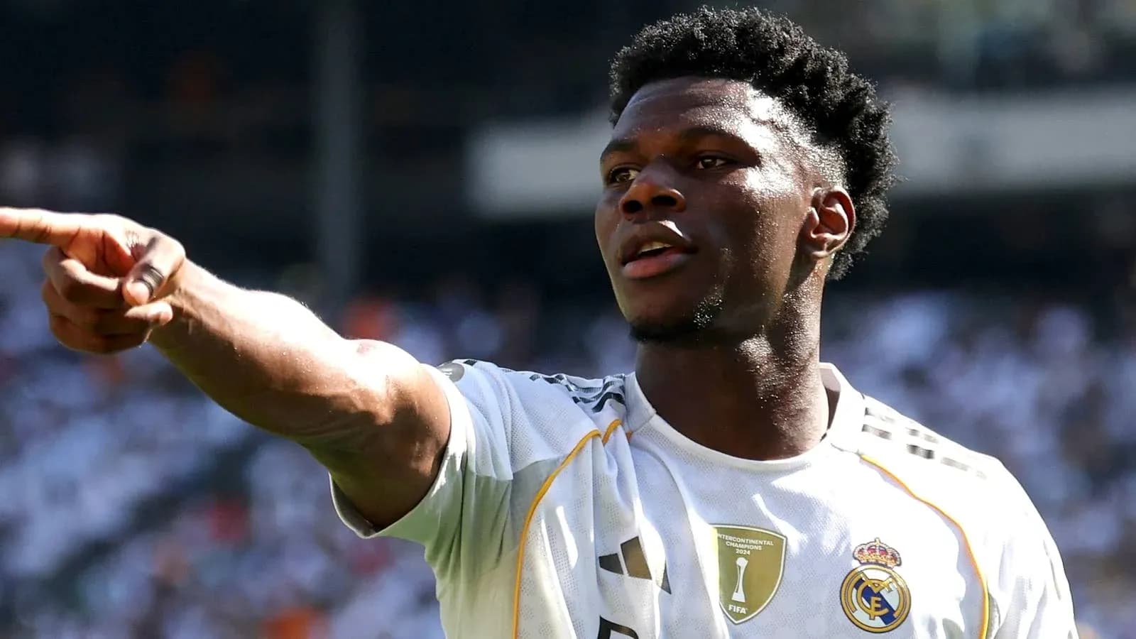Player gesturing during match wearing Real Madrid jersey
