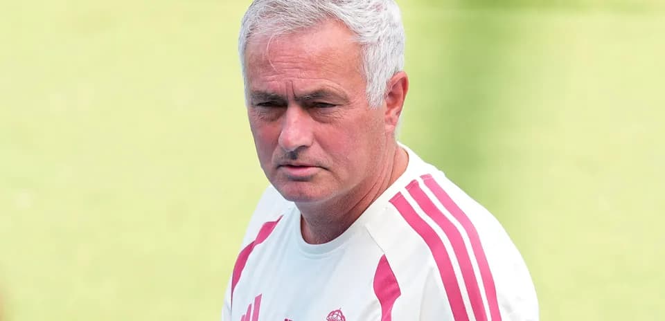 Coach in training shirt on football pitch