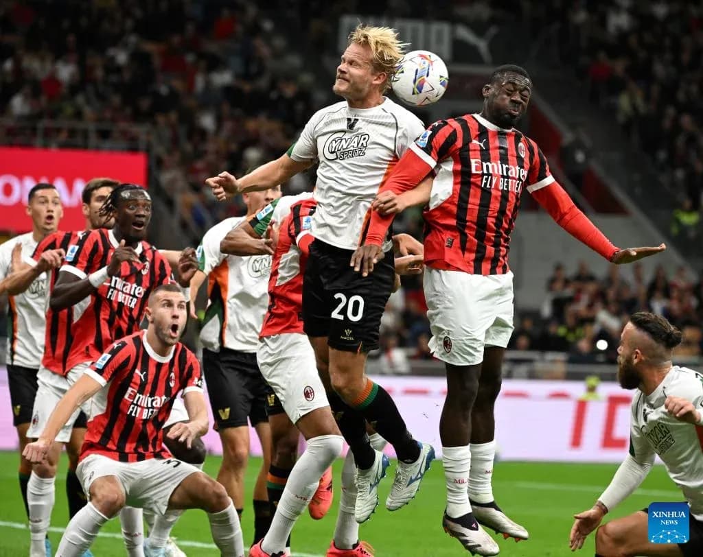Players contesting for the ball during AC Milan match