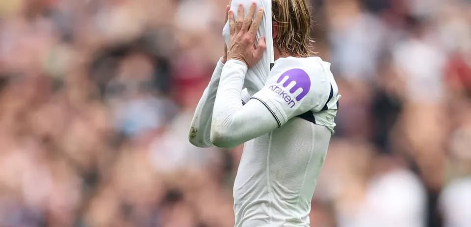 Player covering face with jersey during match