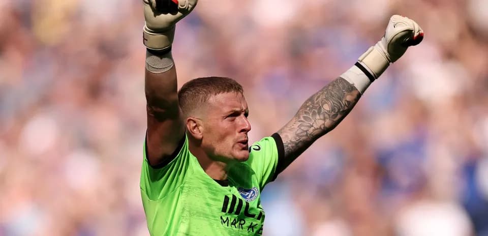 Goalkeeper celebrating with raised arms during match