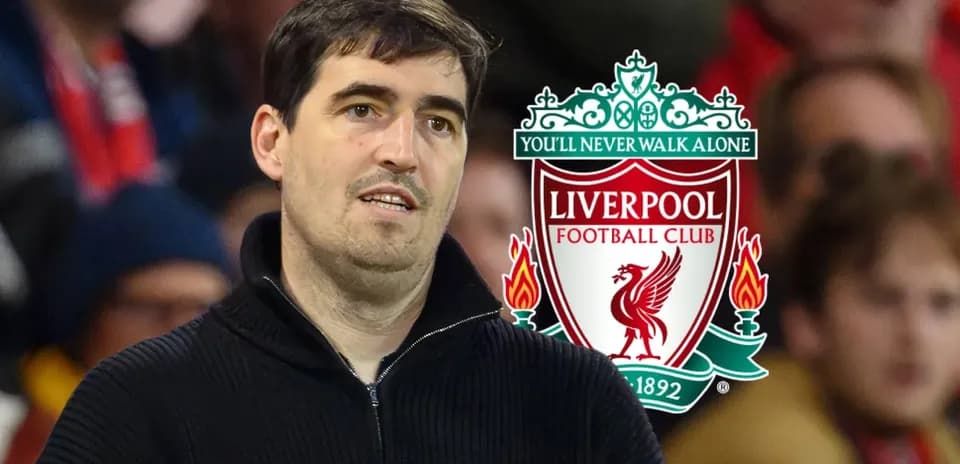 Man observing Liverpool FC logo in stadium